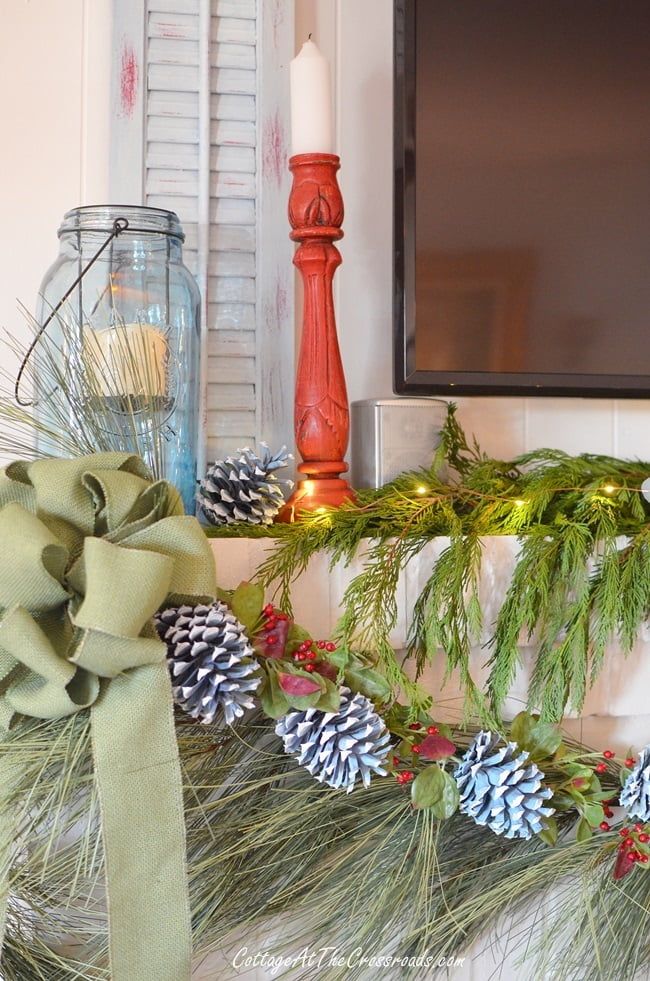 Traditional christmas mantel with painted pine cones