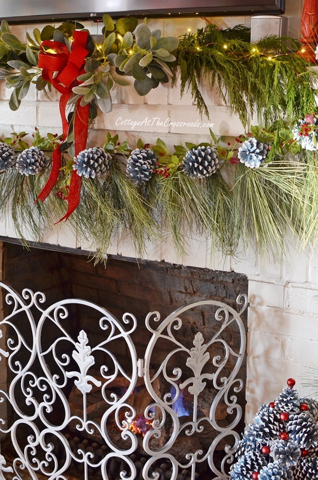 Wispy faux pine garland used on a traditional christmas mantel