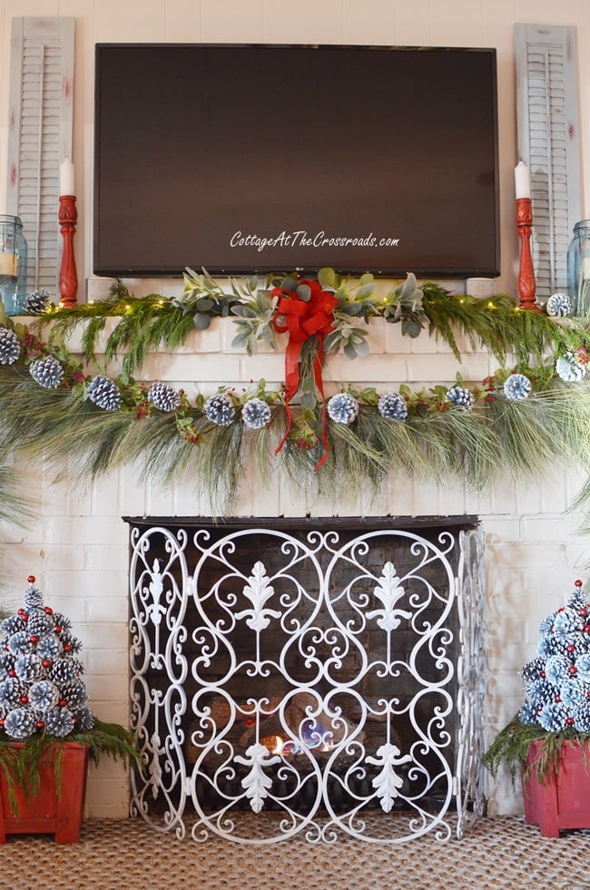 Traditional christmas mantel with pine cone trees at the base