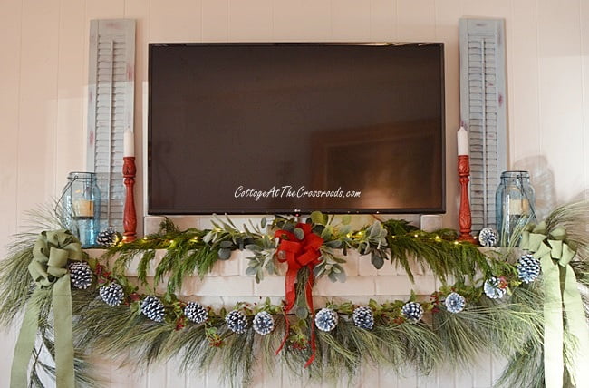 Christmas mantel decorated with painted pine cones