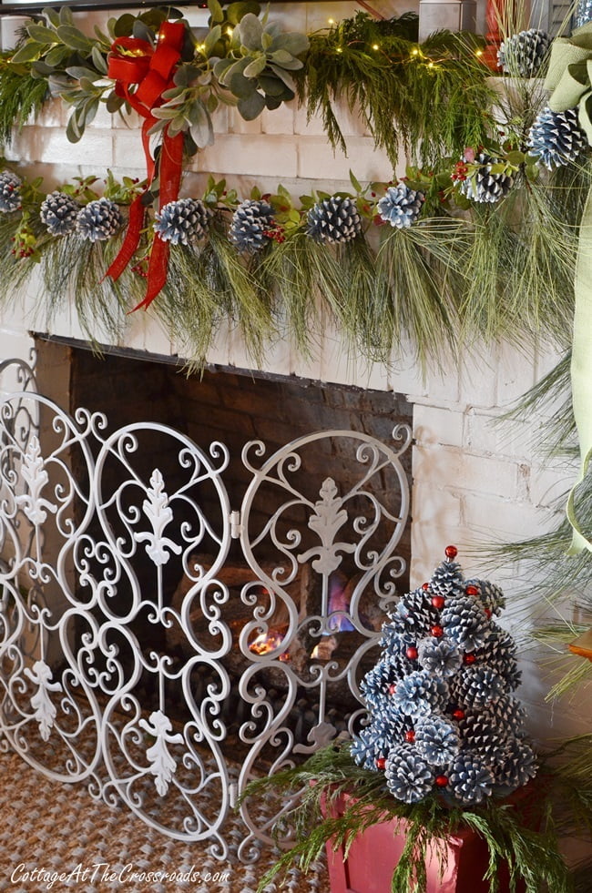 Christmas mantel decorated with painted pine cones