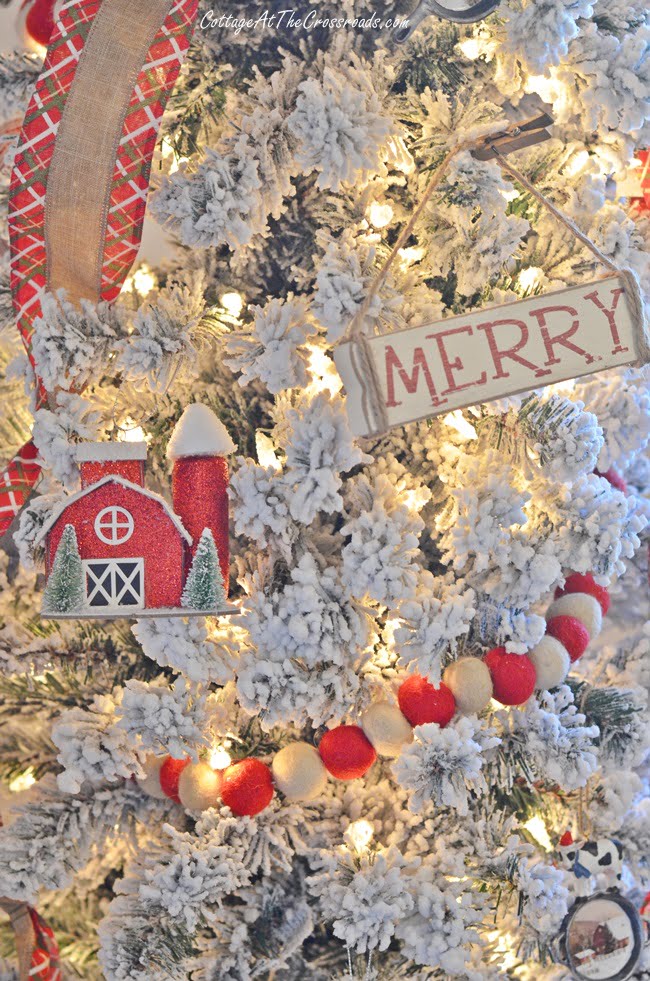 Skinny flocked tree with red barn ornaments