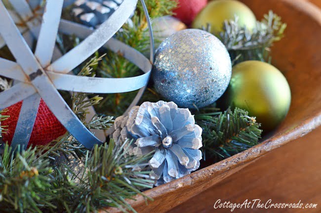 Blue painted pine cones in a dough bowl