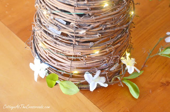 Attaching early spring floral branches to a grapevine cone