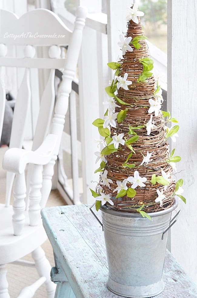 Faux florals on an early spring grapevine cone