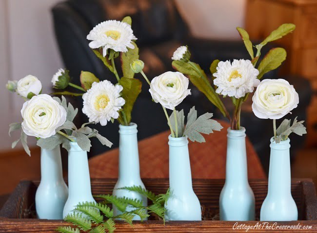 Early spring centerpiece using painted beer bottles