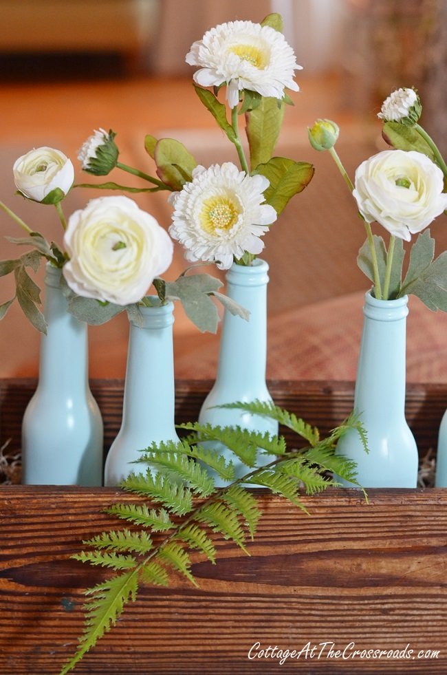 Aqua bottles in a pine box