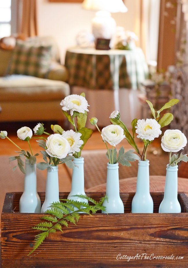 Aqua bottles with faux white flowers