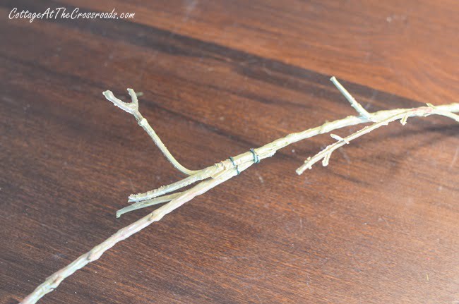 Stripped branches of a faux garland