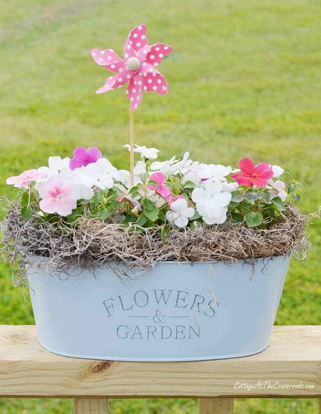 Dollar store metal planter turned into a pretty painted flower container