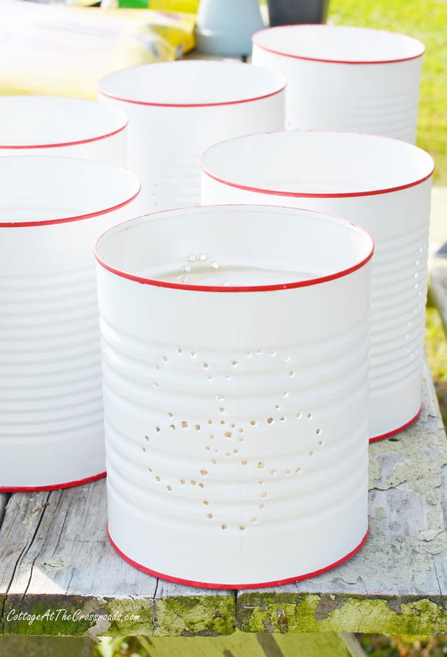 Painted punched tin can lanterns