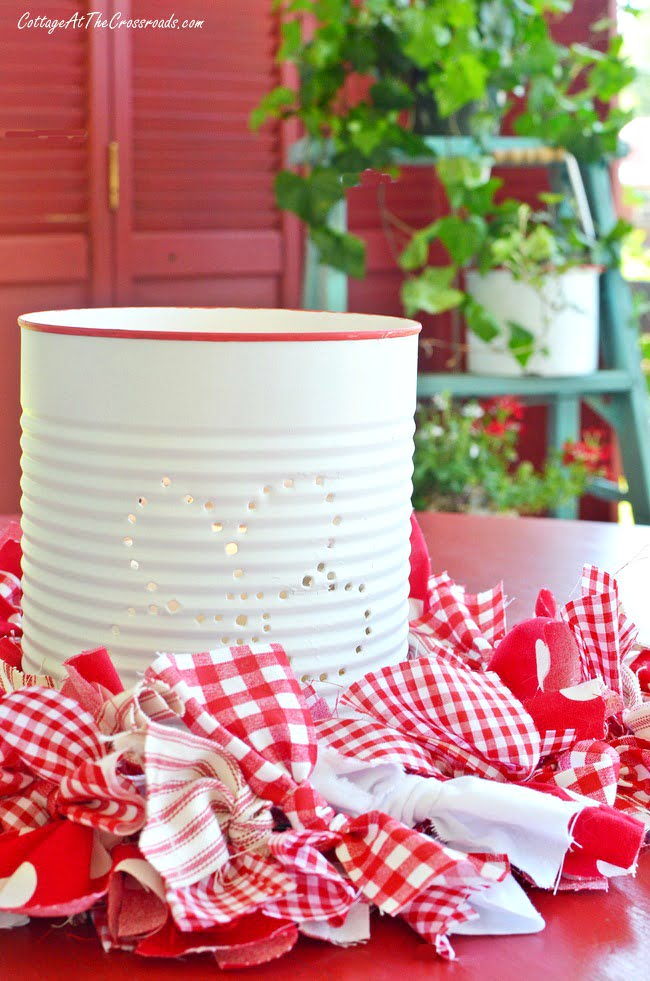 Punching a design in a tin can to make a lantern