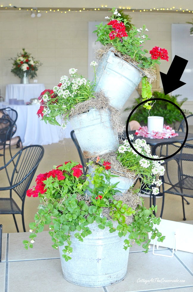 Punched tin can lanterns used as centerpieces at a party