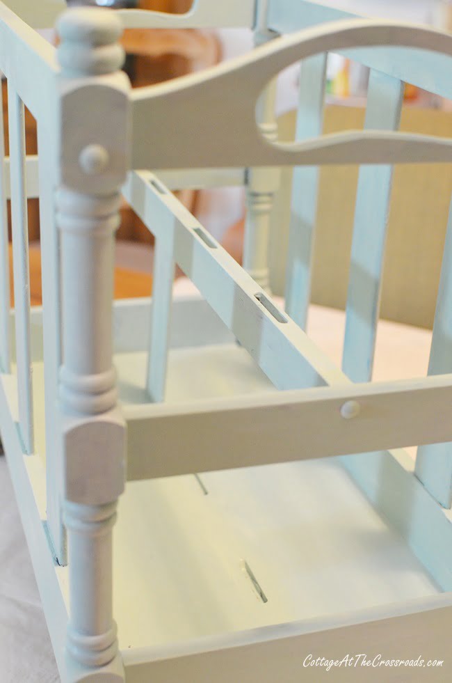 Final coat of paint on a wooden magazine rack