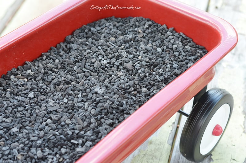 A layer of horticultural charcoal in a fairy garden