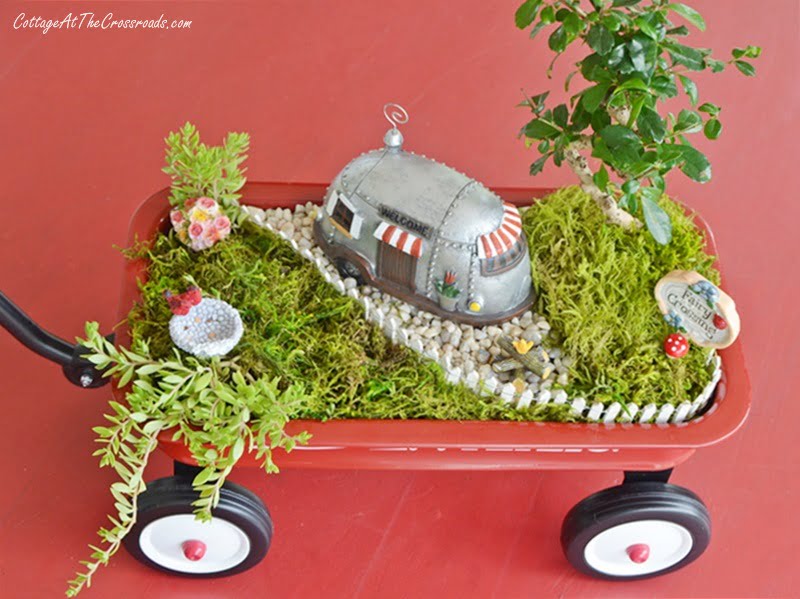 Overview of a fairy garden in a little red wagon
