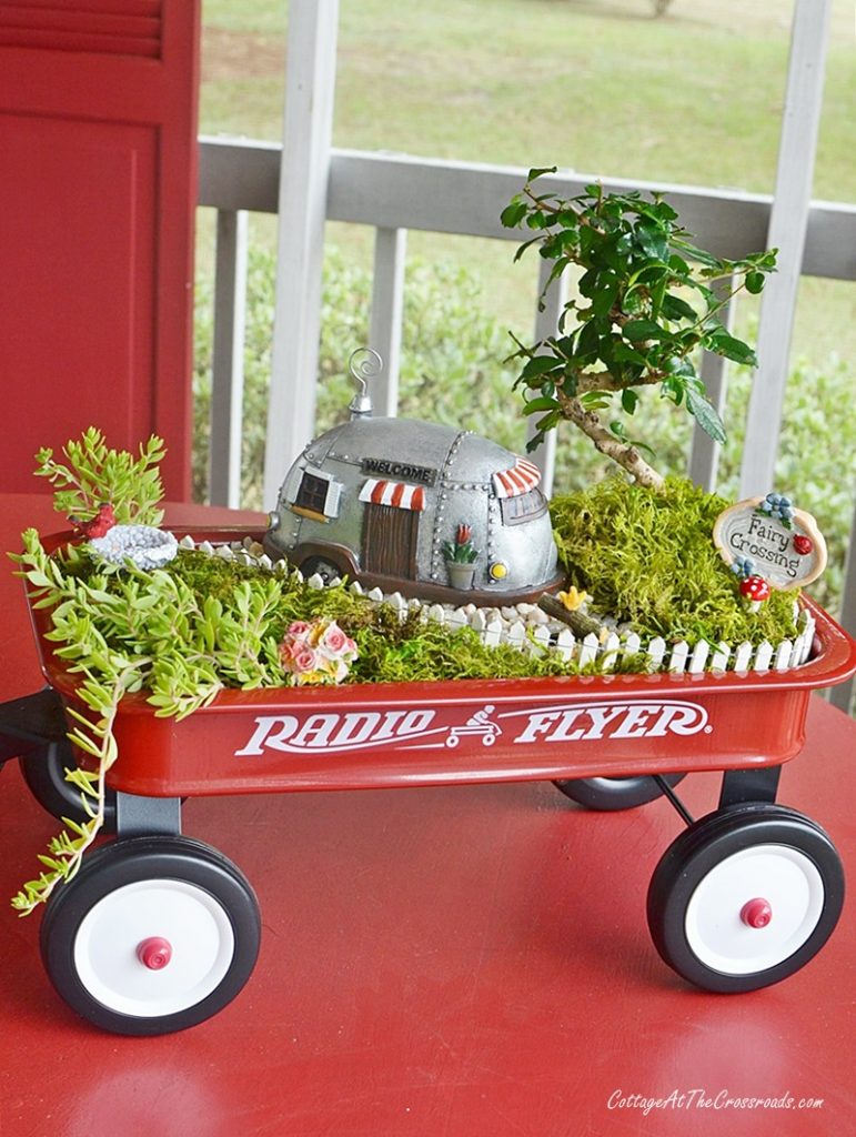 Fairy garden in a red wagon with a camping theme