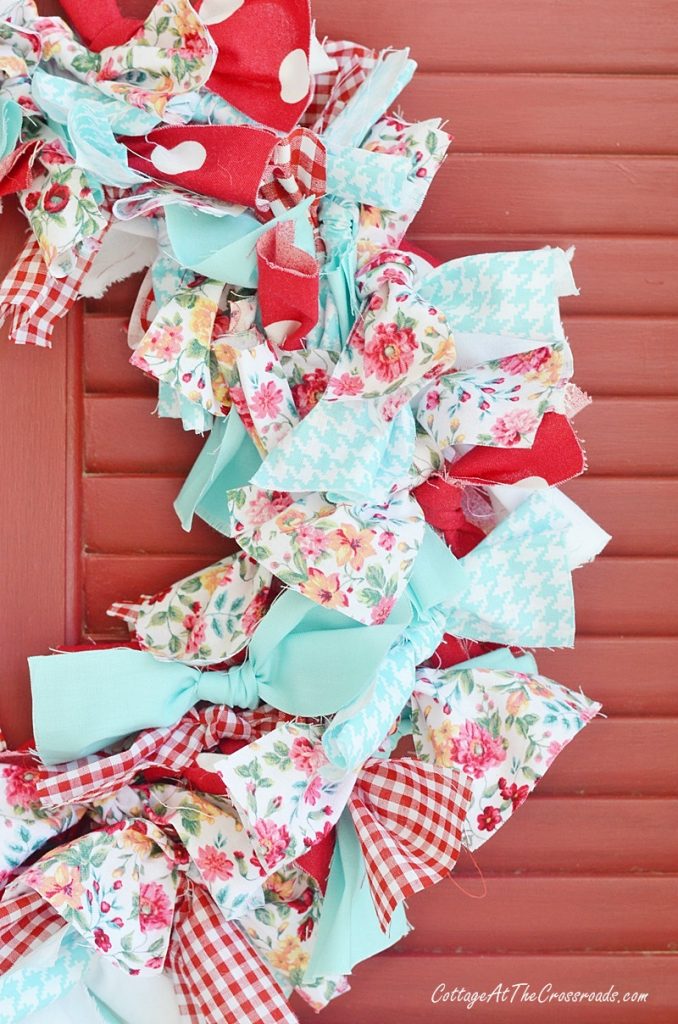 Red. White, and aqua fabrics used in a rag wreath