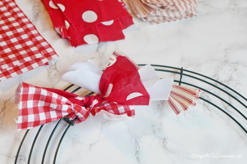 Knotted strips of fabric on a wire wreath form