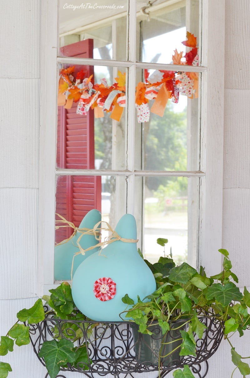 Blue gourd on a fall front porch with a camping theme