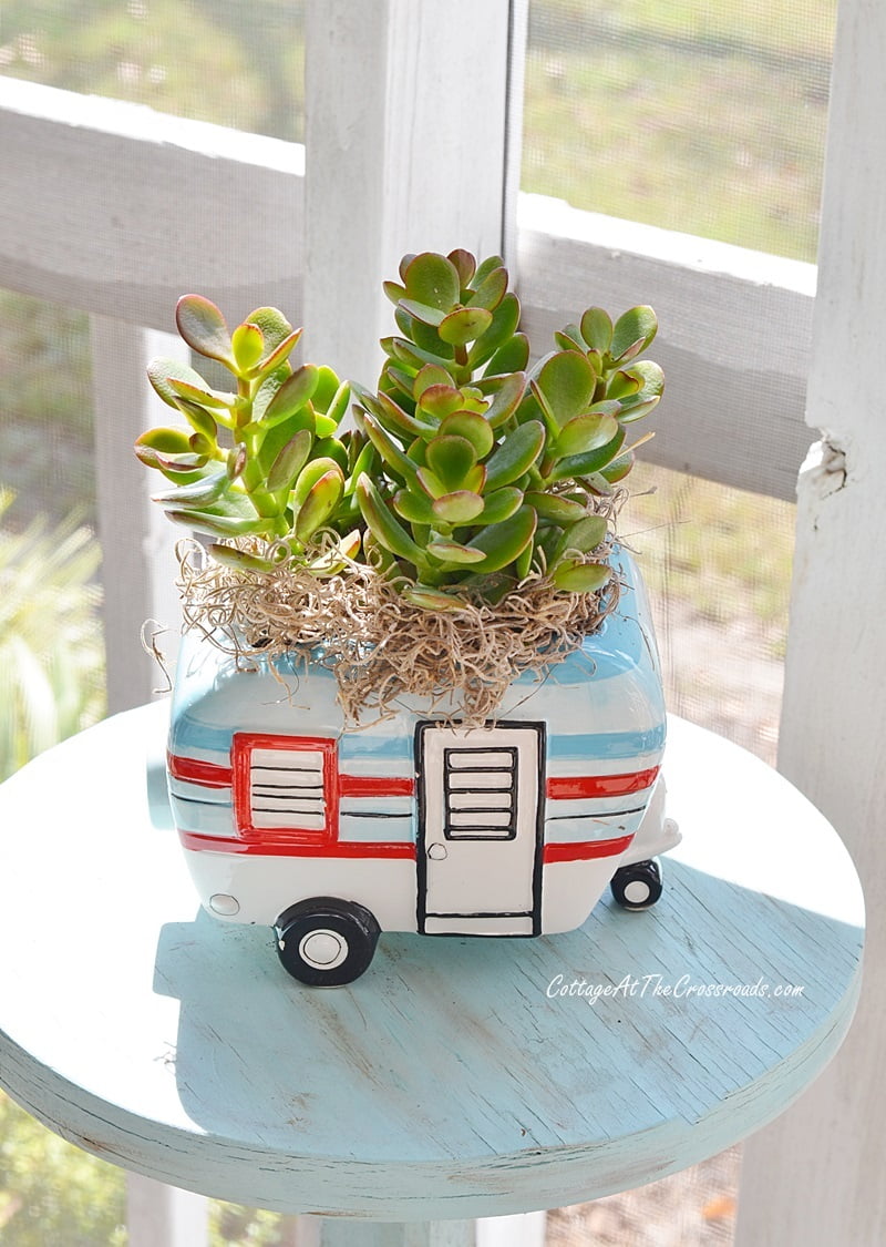 Vintage camper planter on a fall front porch