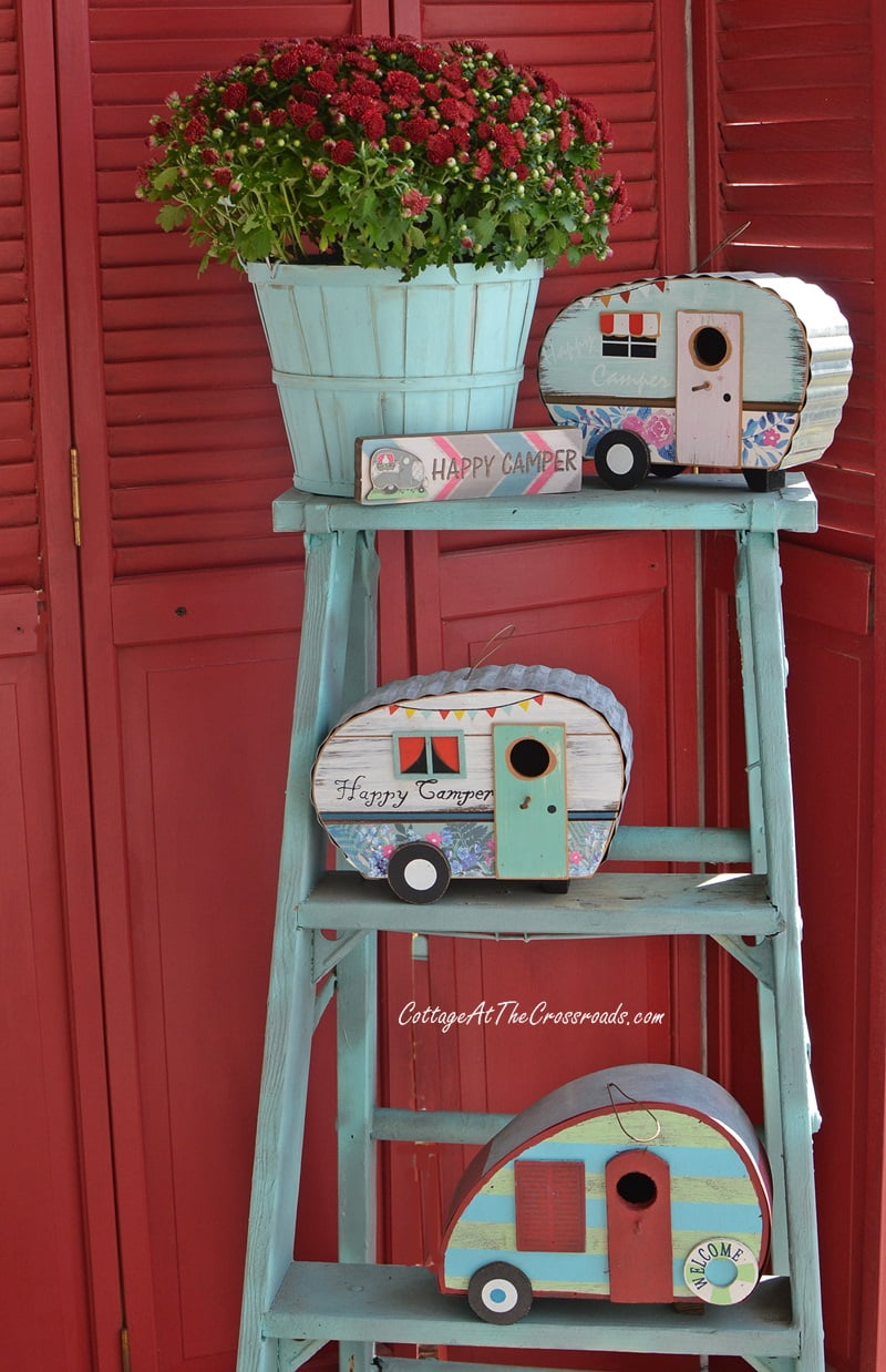 Vintage campers on a blue ladder