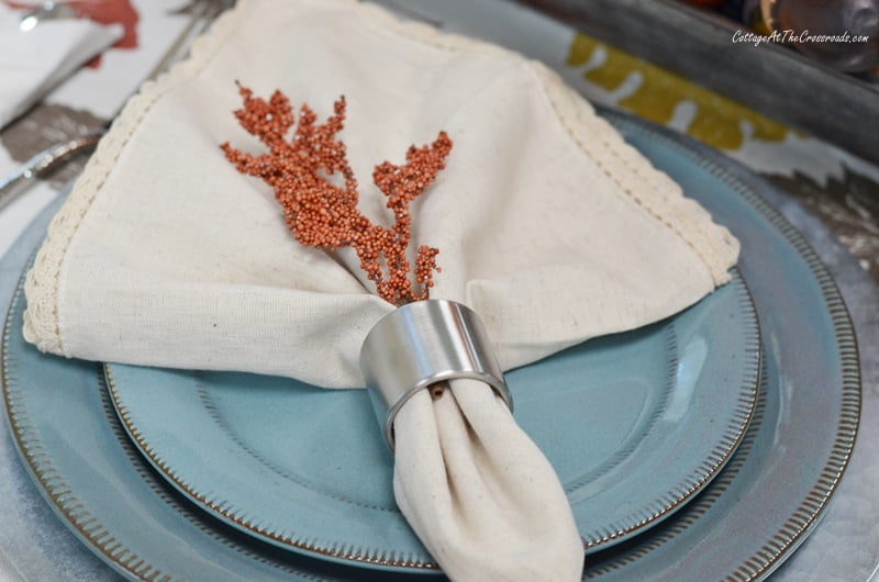 Galvanized chargers and blue plates used in a farmhouse tablescape