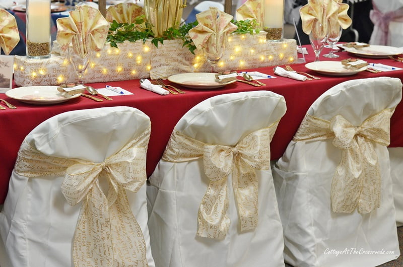 Gold ribbon used on the backs of the chair covers at a tablesetting event