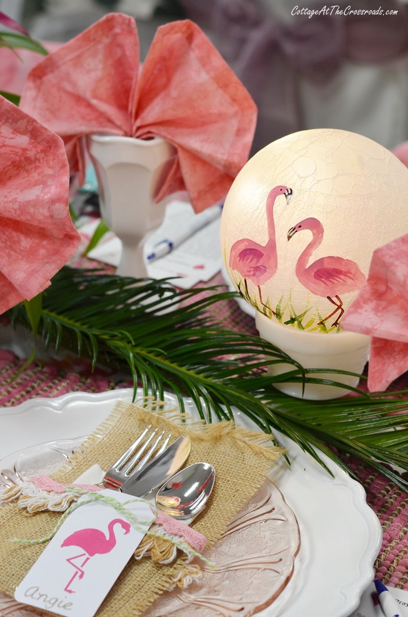 Lighted globe with painted flamingos