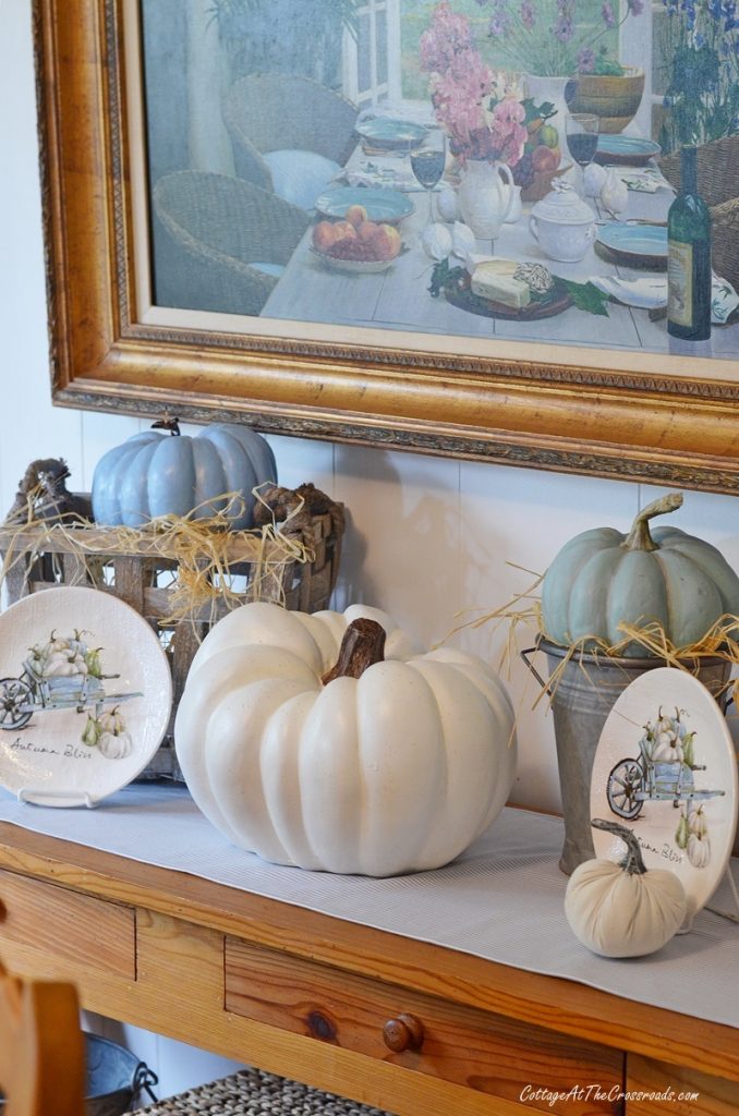 Thanksgiving vignette with pumpkins and plates