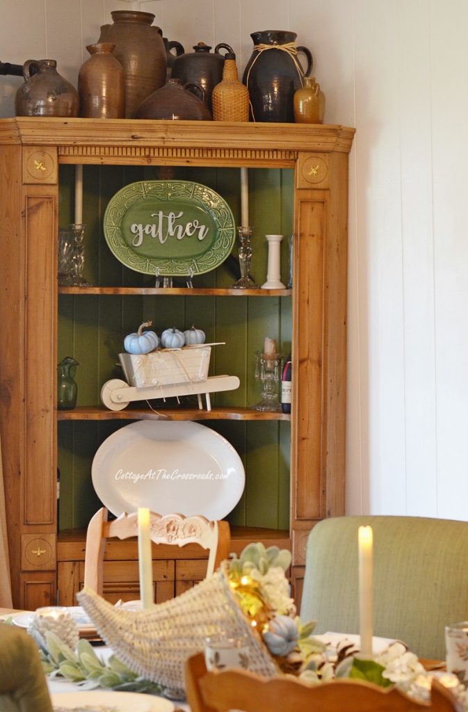 Antique pine corner cabinet with autumn decorations