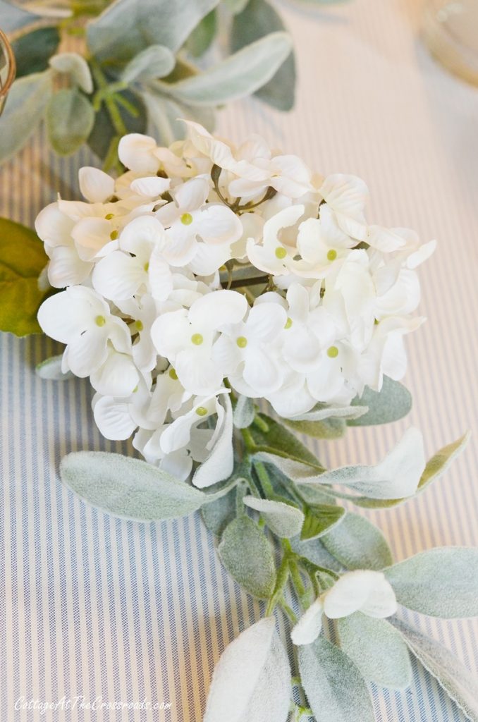 Lamb's ear garland with white hydrangeas tucked into it on a thanksgiving table