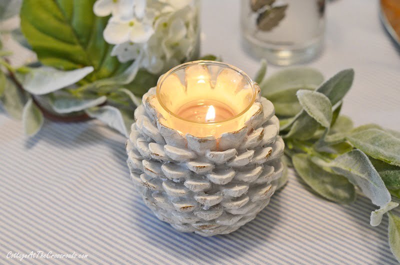 Pine cone candle holders used on a thanksgiving table