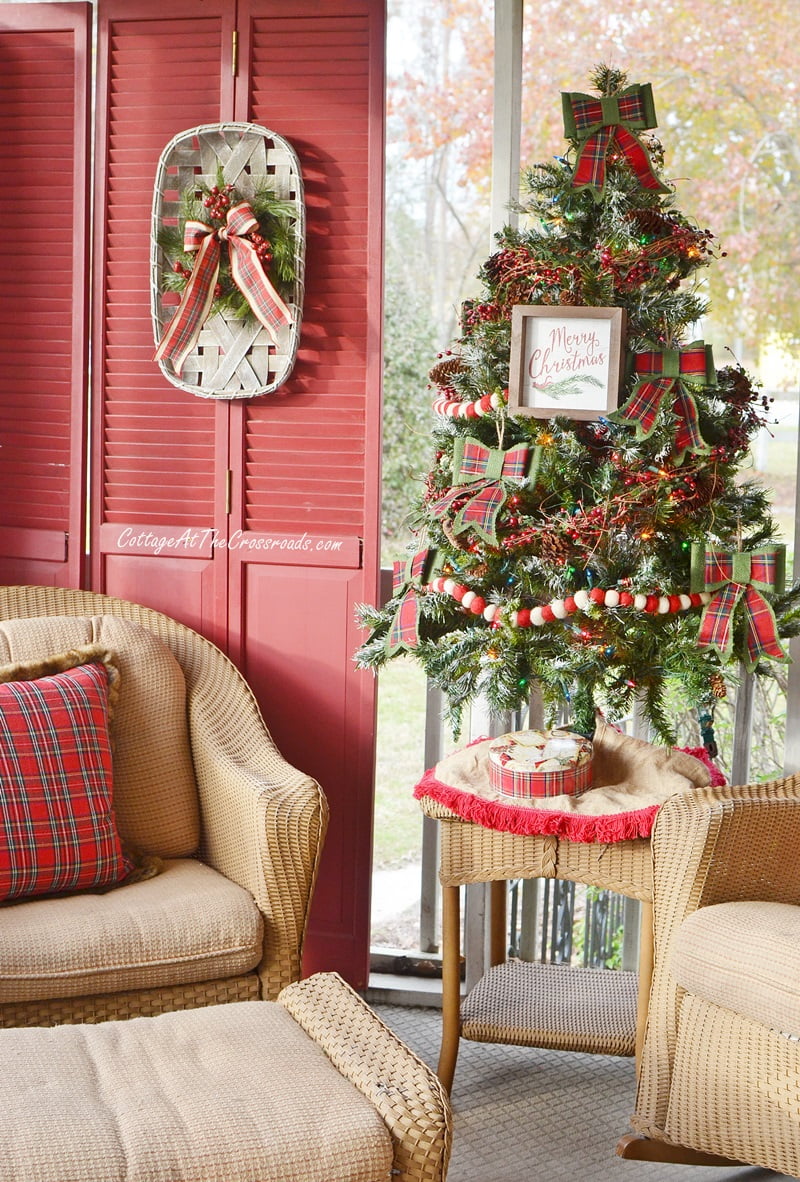 Christmas front porch decorated with traditional reds and greens