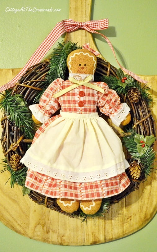 Gingerbread girl mounted on a grapevine wreath