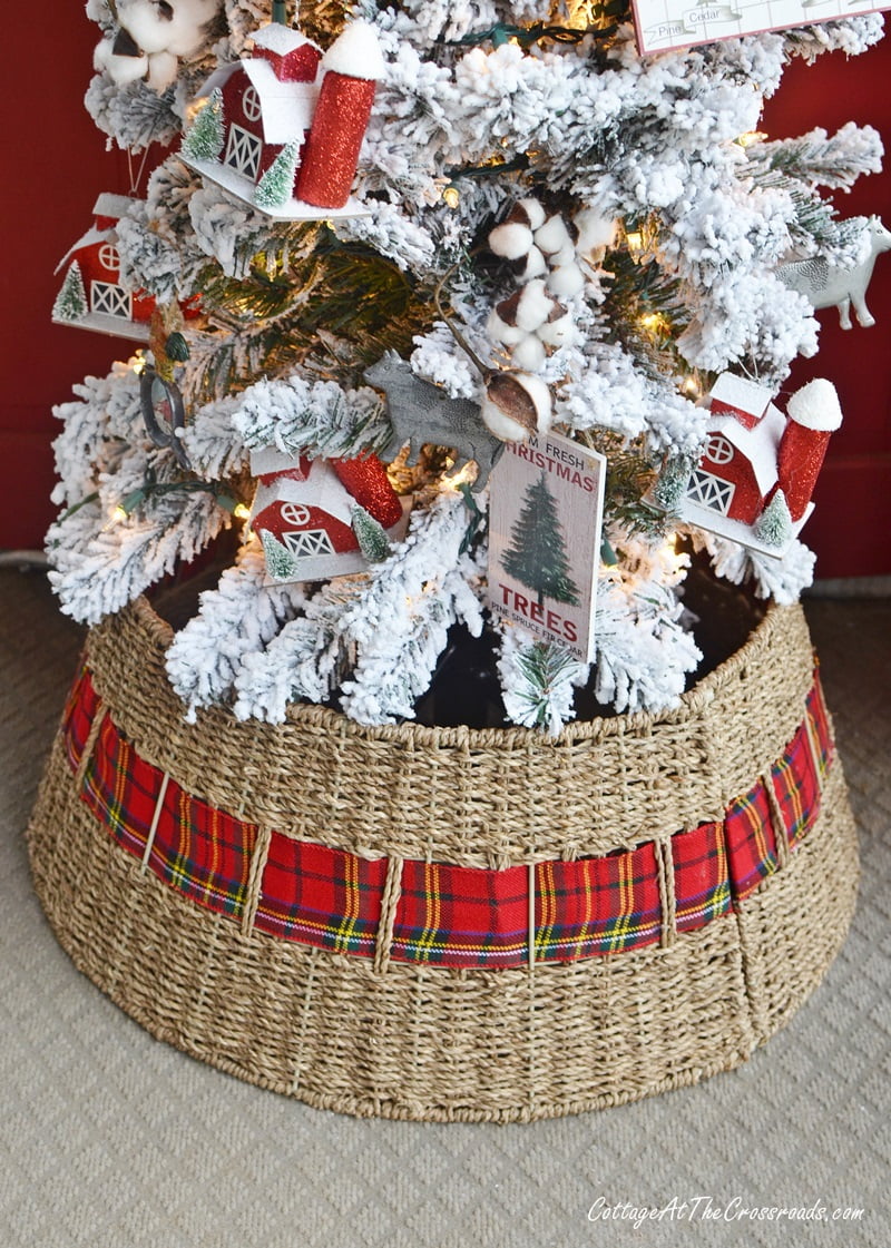 Tree collar with plaid ribbon on a christmas front porch