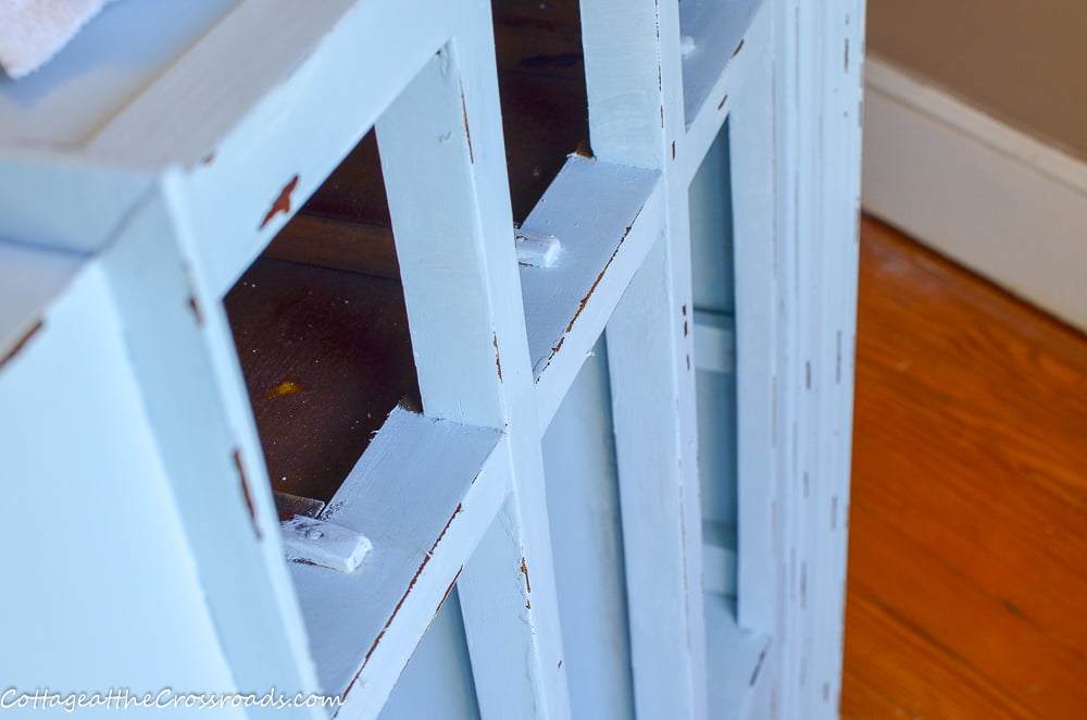 Distressing a repurposed vanity painted with diy chalk paint