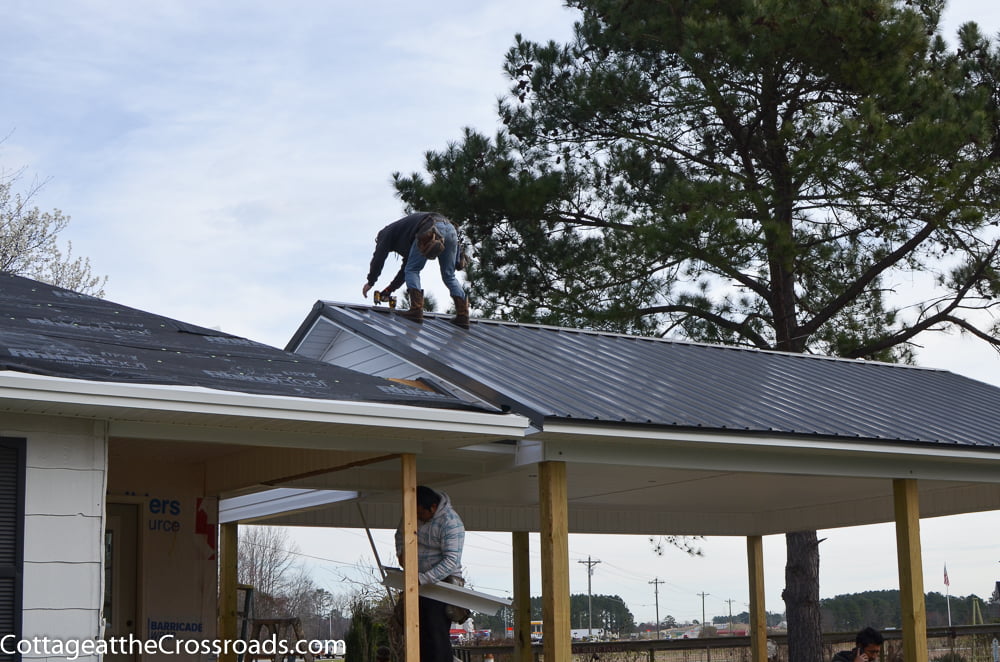 Roofer installing a metal roof