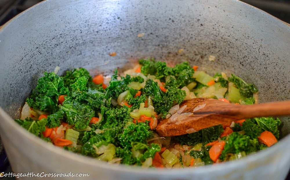 Onions, celery, carrots, and kale used in making a tortellini soup