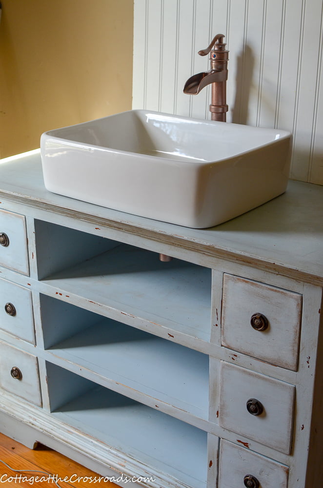 Repurposed vanity with a vessel sink