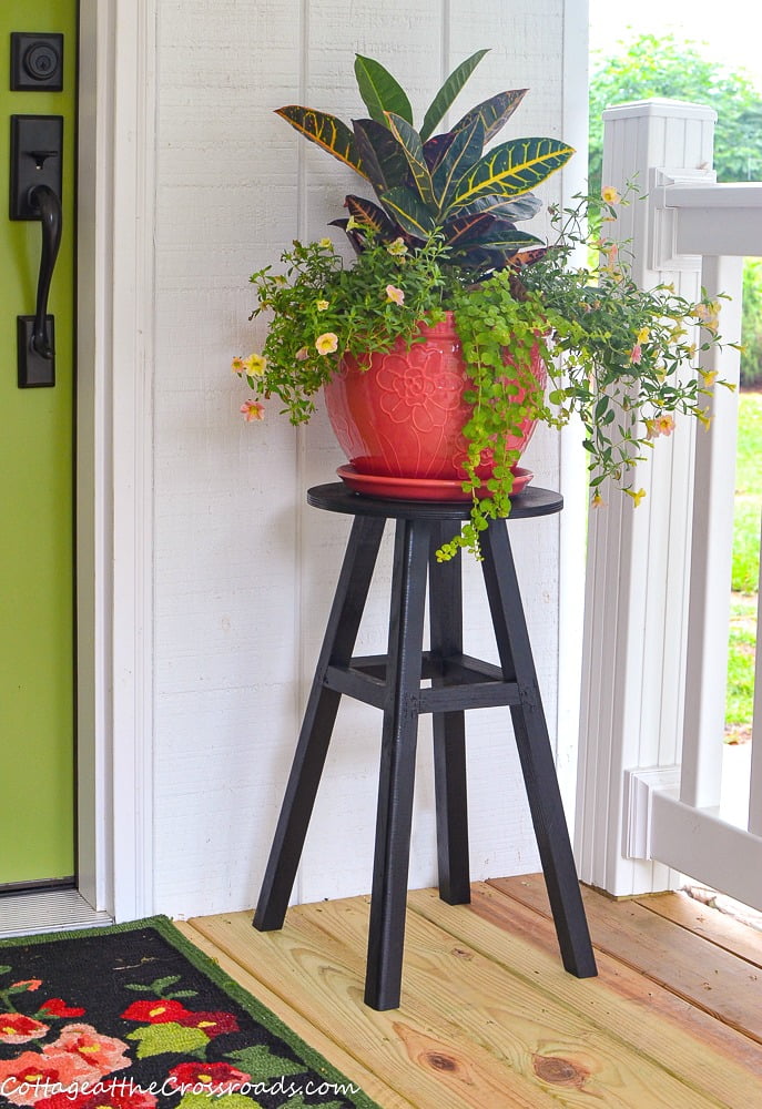 Refurbished stool used as a plant stand