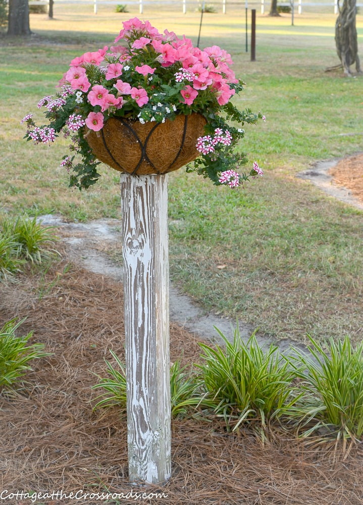 Flower baskets mounted on wooden posts