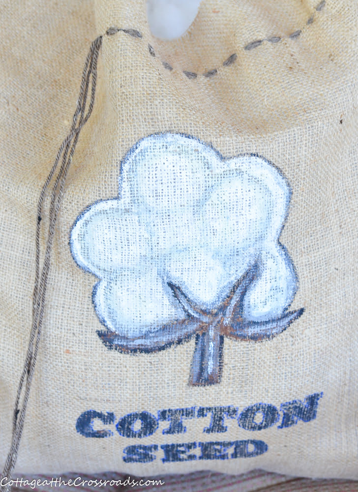 Painted cotton boll on a cotton seed sack