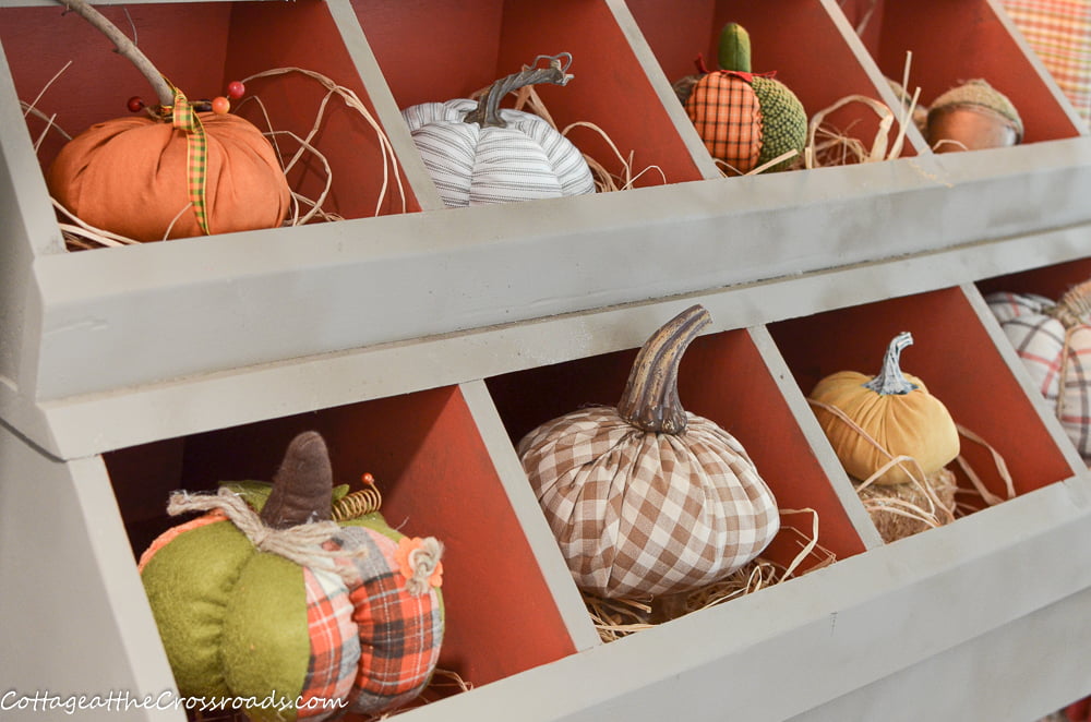 Cubby in mudroom filled with pumpkins