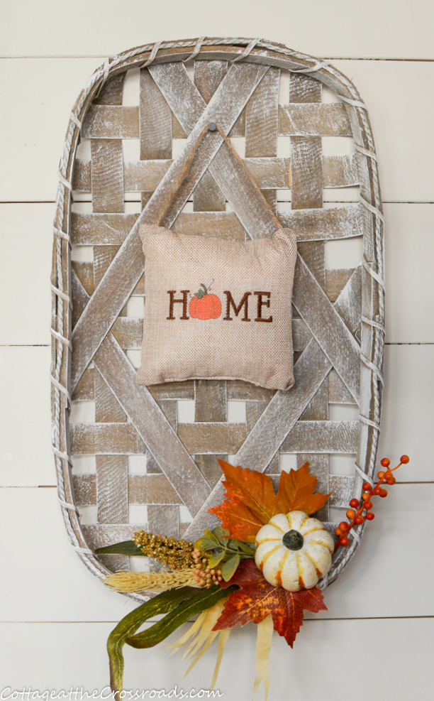 Fall decorated tobacco basket in a mudroom