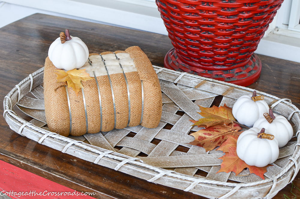 Reproduction cotton bale on a fall porch