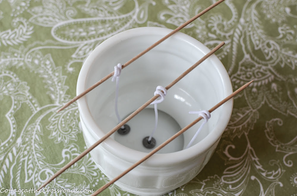 Vintage milk glass container used as a candleholder