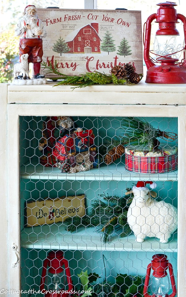 Aqua painted jelly cupboard on a front porch