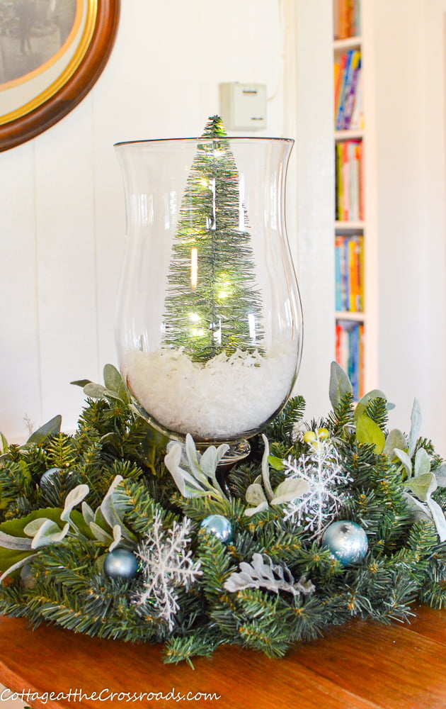 Lighted trees in glass candle holder