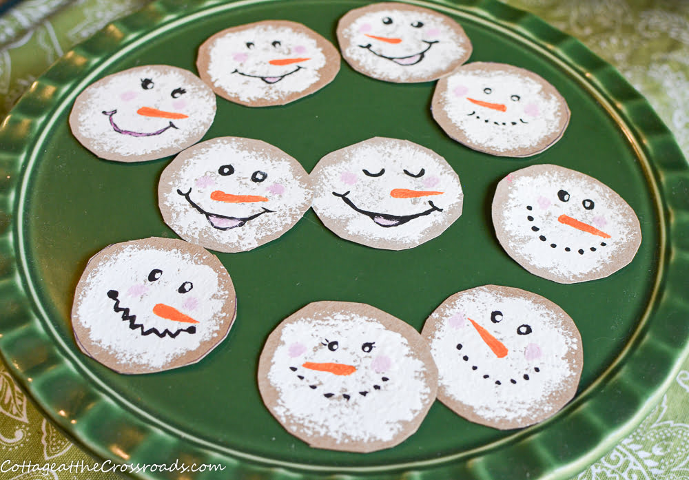 Snowman faces hand painted on cardboard